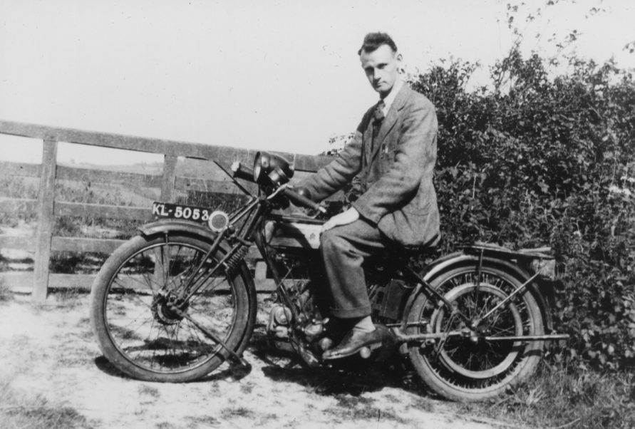 He progressed through a couple of second-hand motorbikes until in 1925, when only twenty-one, he purchased his first brand-new ‘bike from Ernest Blackton at Wolfe Garage on the Green. This was a Triumph model P with electric lighting and a bulb horn… 